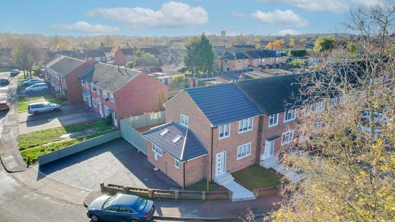 Photograph of the individual dwelling developed on a corner plot alongside existing houses